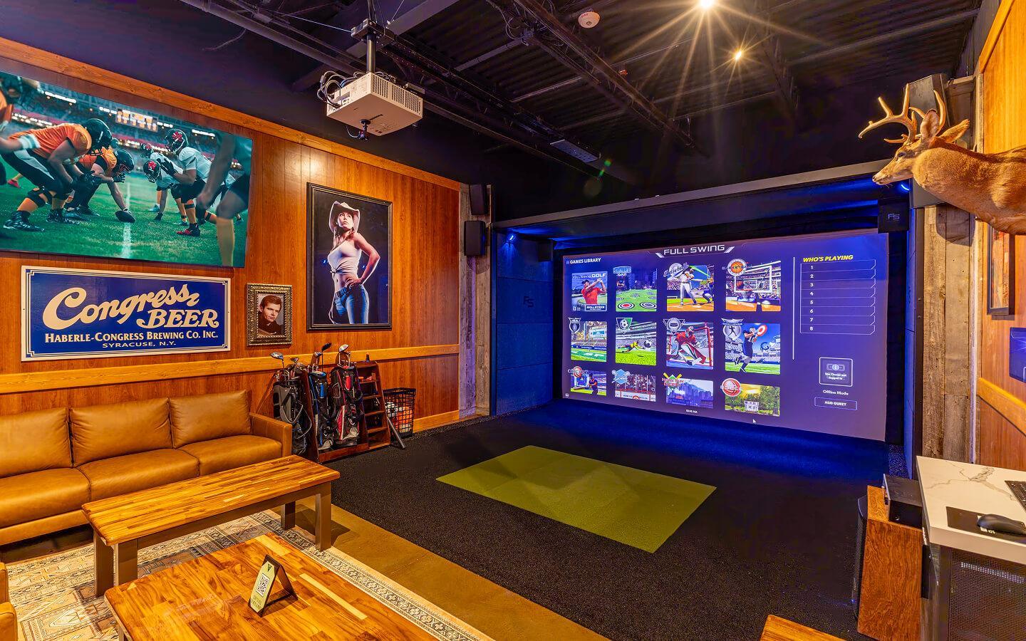 A cozy room with a golf simulator, wooden furniture, golf clubs, sports posters on wood-paneled walls, and a mounted deer head creates a sports-themed lounge atmosphere reminiscent of Eddie's Tavern. | Terrain